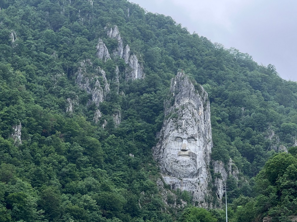 creepy stone face carved into the mountainside