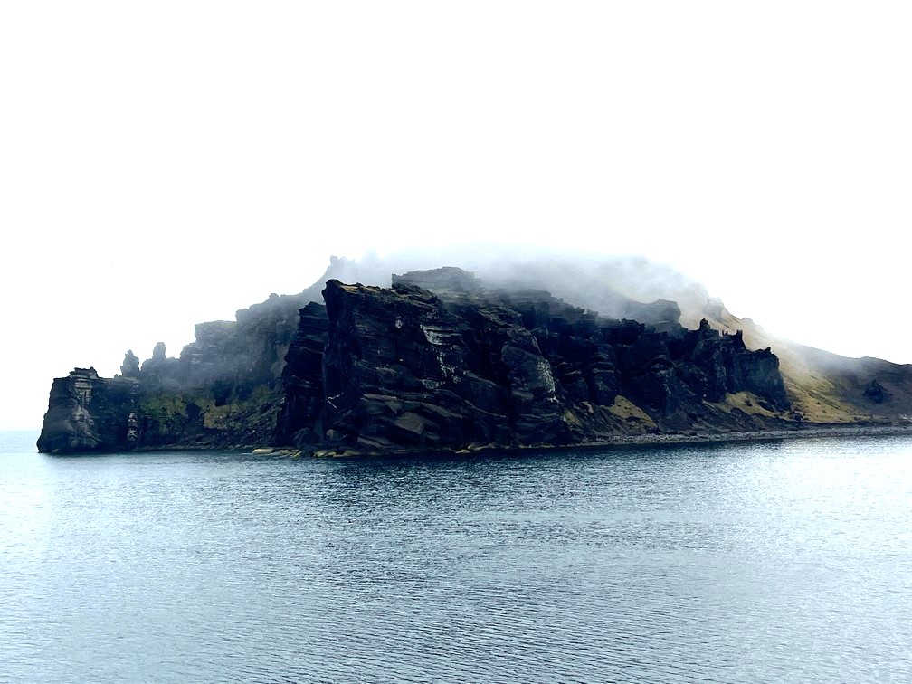 Aurora Expeditions Jan Mayen’s cliffs in fog - photo by Golding Travel
